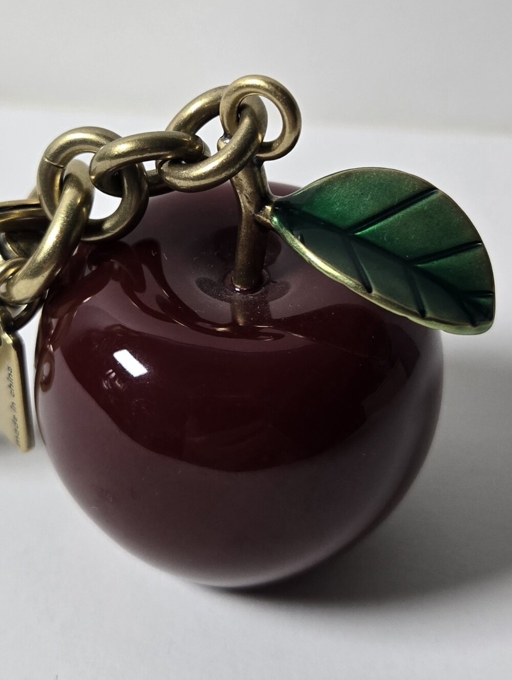 Coach Burgundy Apple Charm Keychain with Green Leaf Accent